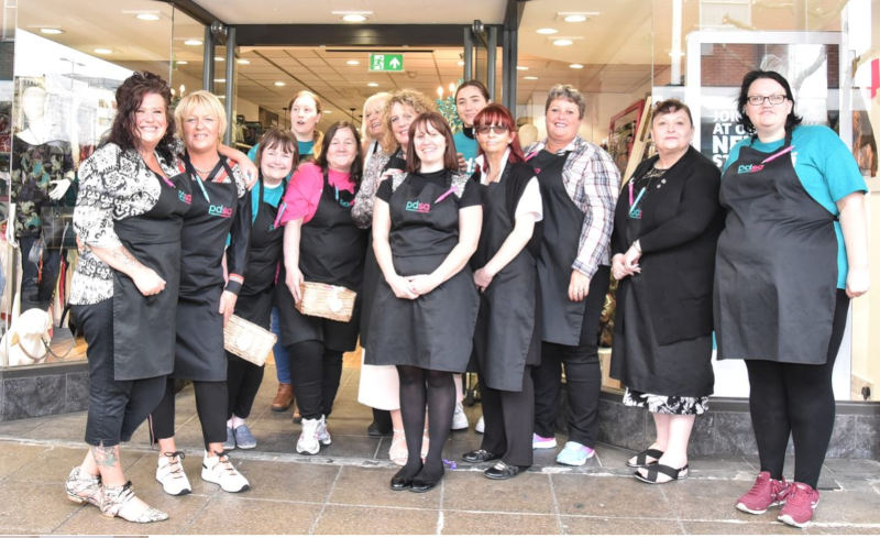 A group of volunteer staff stood outside a PDSA shop